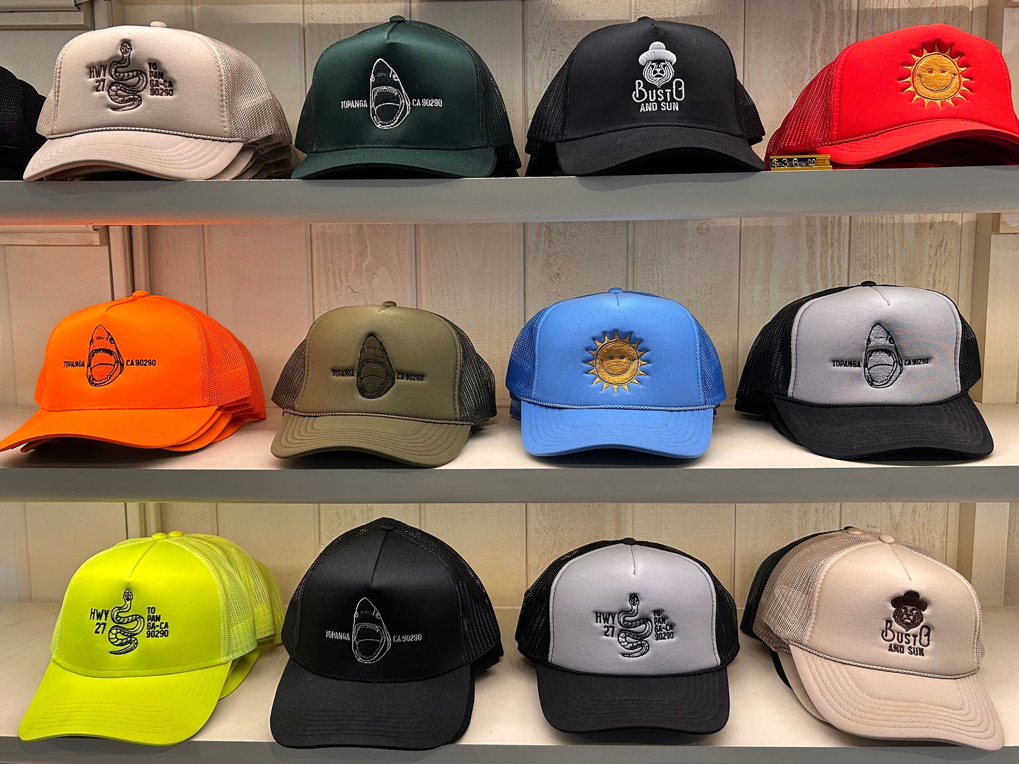A photo of a variety of Busto and Sun Truck hats on shelves.