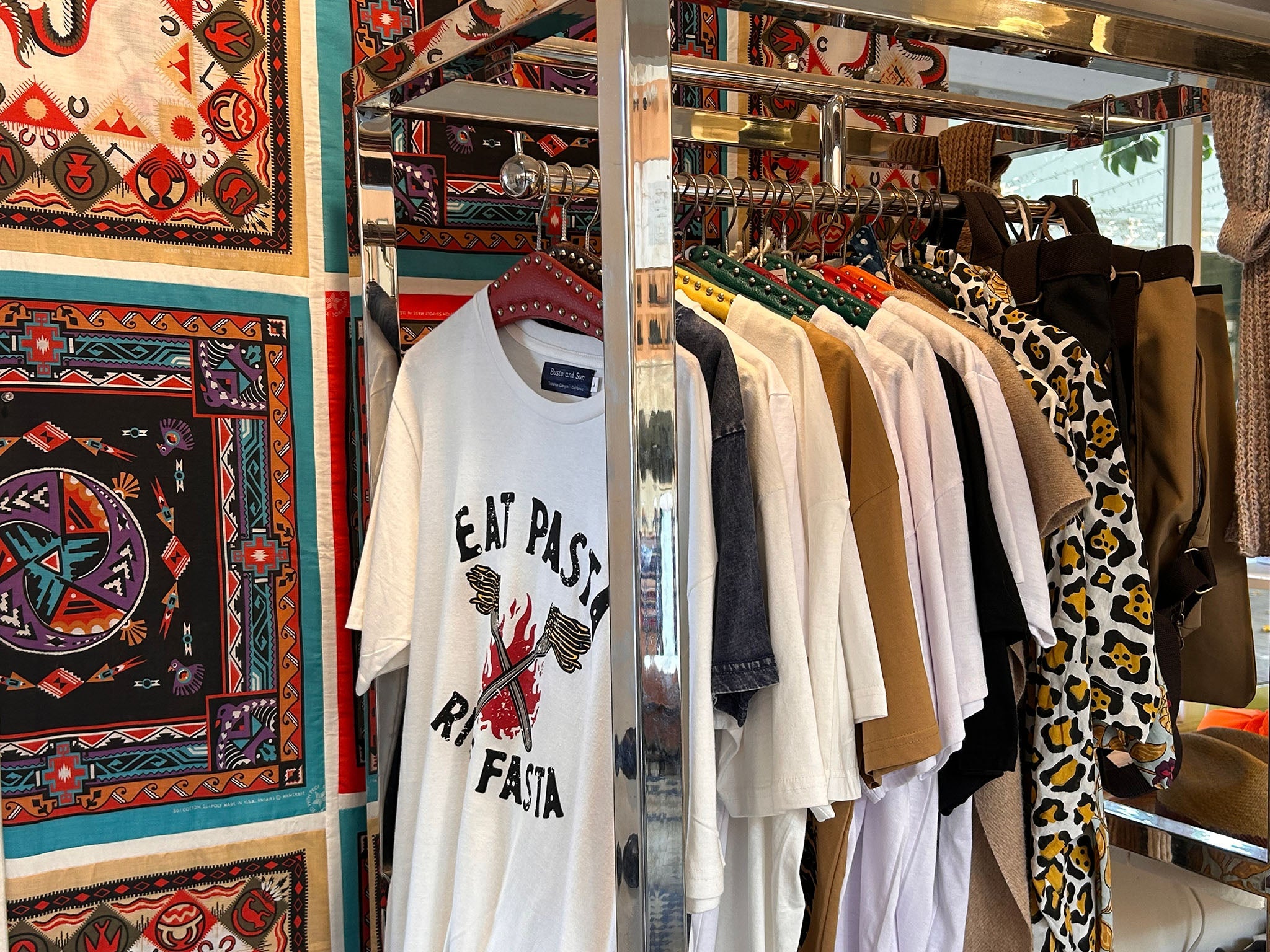A photo of a clothing rack full of Busto and Sun apparel.