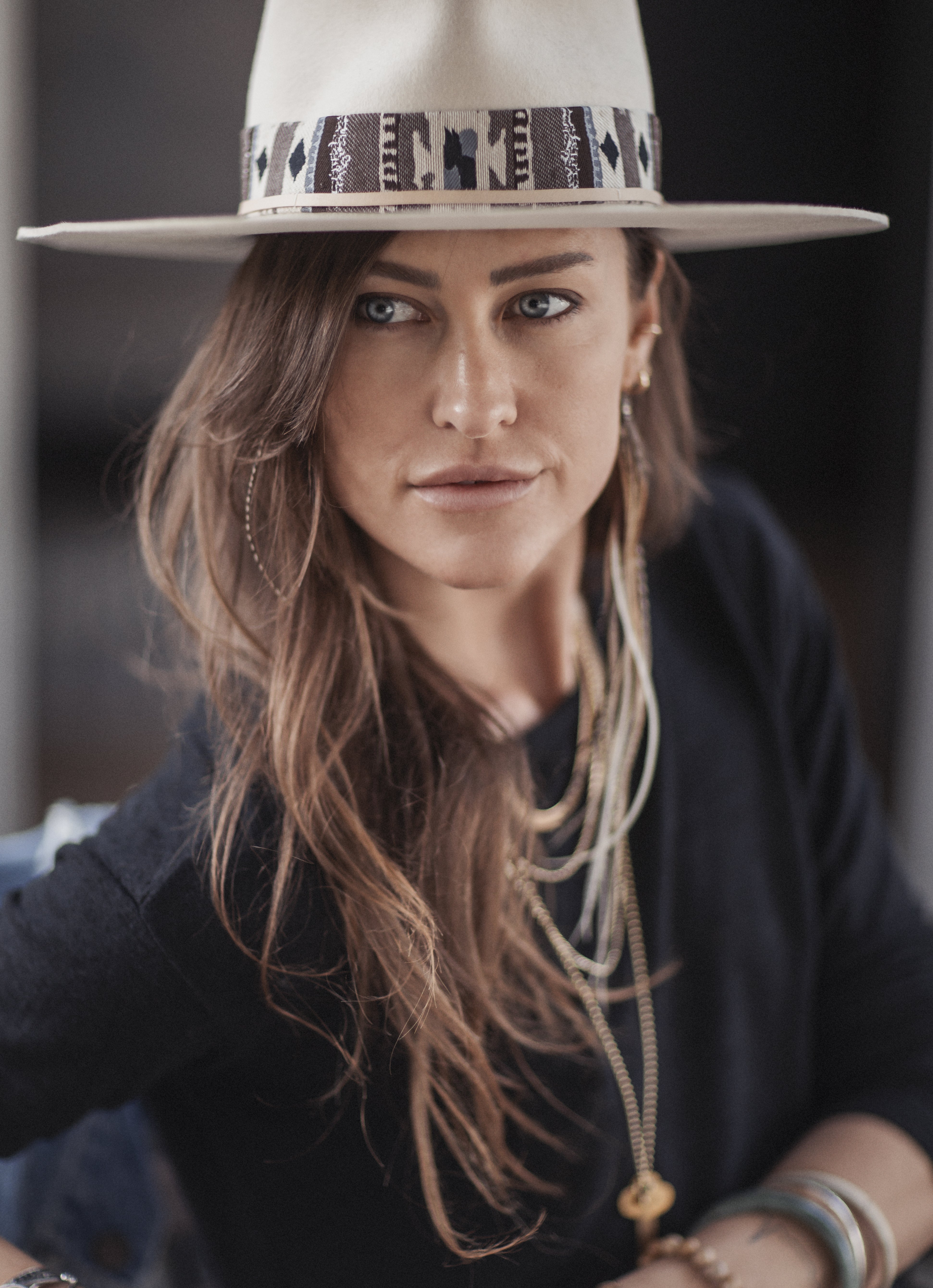 Photo of a beautiful woman wearing a custom Busto and Sun hat